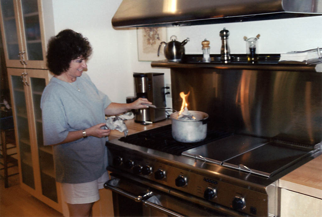 Mom cooking newspaper (don't ask) in her new kitchen. (Category:  Family)