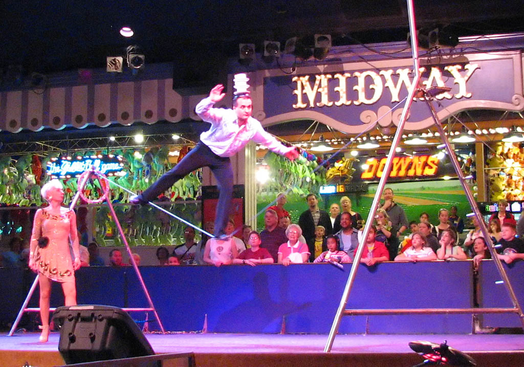 Slackliner catching teacups on his head at Circus Circus. (Category:  Rock Climbing)