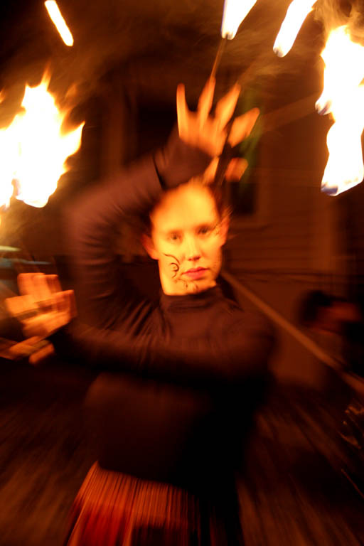 Fire juggling.  This was taken by manipulating the zoom during the exposure.  I like the effect. (Category:  Photography)