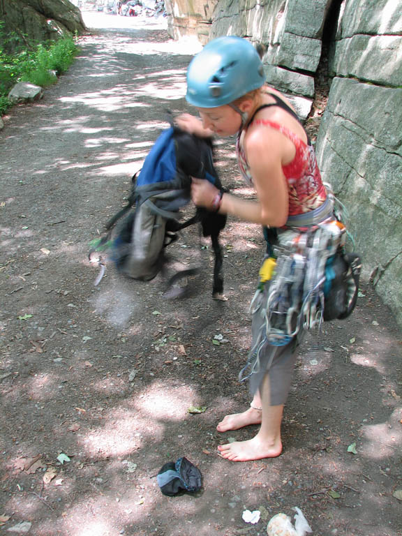 Making sure the snake is no longer in her backpack. (Category:  Rock Climbing)