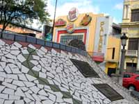 One of many brilliant tile mosaics in the Parque Central.  In the background is the Palace Theater. (Category:  Travel)
