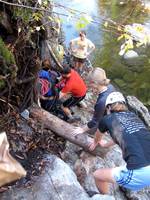 Passing packs down to the stream crossing. (Category:  Rock Climbing)