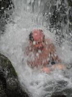 Tom getting pounded by the waterfall. (Category:  Travel)
