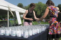 Anna and Emma set up the jars. Instead of drinking glasses, each guest had a personal mason jar. The jars also served as name cards, as they were stuffed with papers indicating people's assigned tables, as well as other helpful information about how to be a good citizen of the luncheon. (Category:  Party)