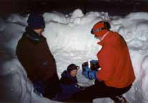 Ann, Joanna and me getting water from a stream flowing 10 feet below the surface of the snow. (Category:  Photography)