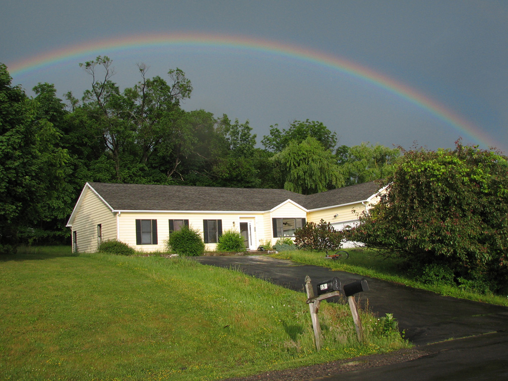 Biking home from Ithaca Fest, I got caught in a horrific downpour.  The reward was this amazing 180 degree rainbow when I reached home. (Category:  Residence)