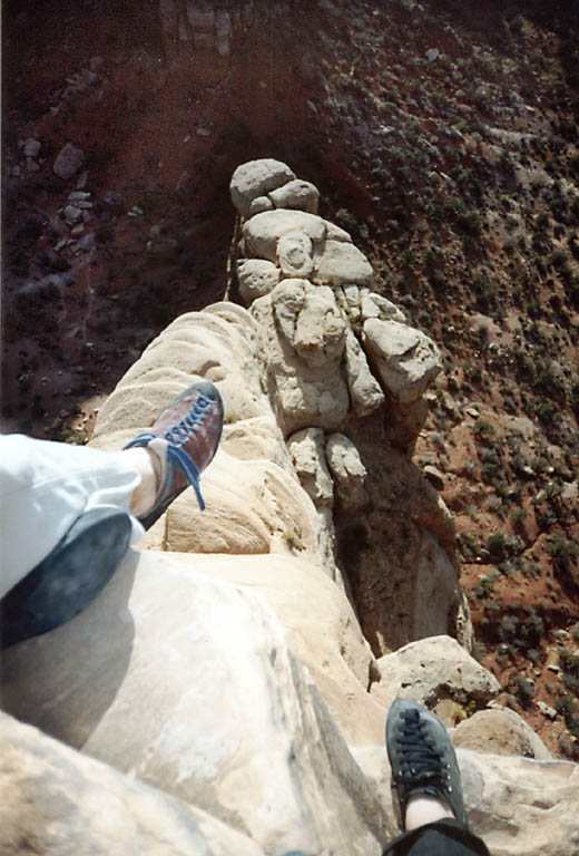 Dangling feet over the edge of the summit. (Category:  Rock Climbing)