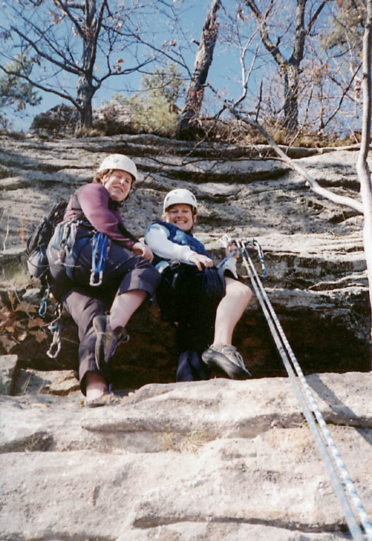Heidi and Jen at the top of Frog's Head, showing some leg. (Category:  Rock Climbing)