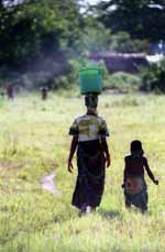 Woman carrying water with her daughter. (Category:  Travel)