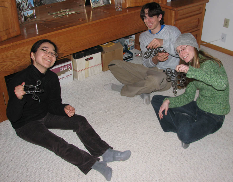 Iori, Paul and Deena hooked on tavern puzzles. (Category:  Party)