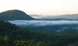 Fog hanging in the valley as the sun rises. (Category:  Rock Climbing)