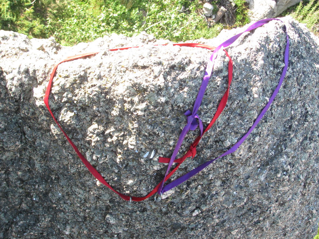 Draped slings. This constitutes a redundant rappel anchor in the Needles. (Category:  Rock Climbing)