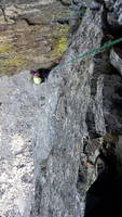 Camille puzzling out the crux move on the seventh pitch (Category:  Climbing)