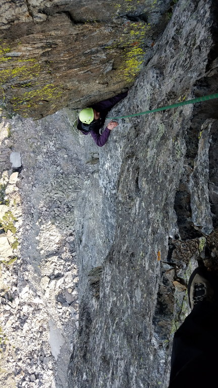 Camille puzzling out the crux move on the seventh pitch (Category:  Climbing)